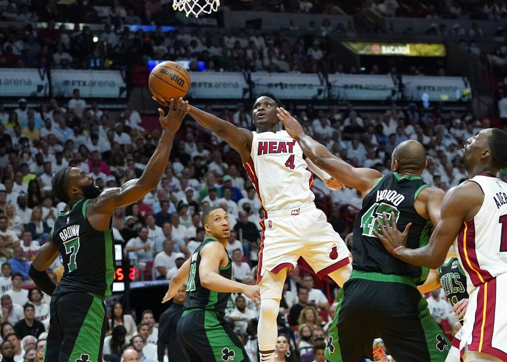 Miami Heat guard Victor Oladipo (4) drives to the basket as Boston Celtics guard Jaylen Brown (7) defends during the first half of Game 5 of the NBA basketball Eastern Conference finals playoff series, Wednesday, May 25, 2022, in Miami. (AP Photo/Lynne Sladky)