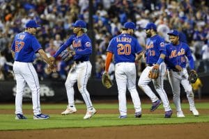 New York Mets shortstop Francisco Lindor and relief pitcher Seth Lugo, left, green one another, next to Pete Alonso (20), Luis Guillorme (13), and Eduardo Escobar (10) following the team's baseball game against the Philadelphia Phillies, Saturday, May 28, 2022, in New York. (AP Photo/Jessie Alcheh)