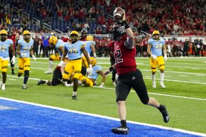 Media by Associated Press - FILE - Northern Illinois quarterback Rocky Lombardi runs into the end zone for 5-yard touchdown during the second half of of the Mid-American Conference championship NCAA college football game against Kent State on Dec. 4, 2021, in Detroit. The conference is selling the rights to its data and statistics to a company called Genius Sports, which will in turn sell it to sportsbooks. (AP Photo/Carlos Osorio, File)