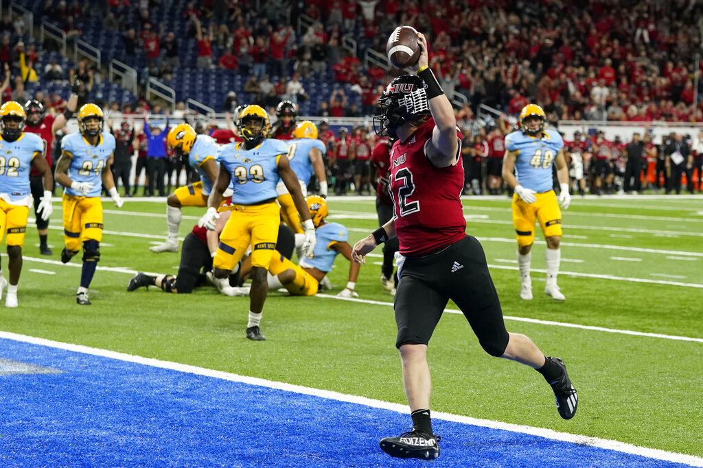 Media by Associated Press - FILE - Northern Illinois quarterback Rocky Lombardi runs into the end zone for 5-yard touchdown during the second half of of the Mid-American Conference championship NCAA college football game against Kent State on Dec. 4, 2021, in Detroit. The conference is selling the rights to its data and statistics to a company called Genius Sports, which will in turn sell it to sportsbooks. (AP Photo/Carlos Osorio, File)