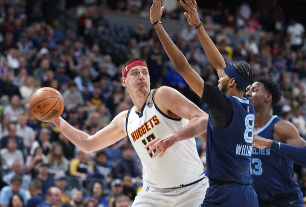 Media by Associated Press - FILE - Denver Nuggets center Nikola Jokic looks to pass the ball as Memphis Grizzlies guard Ziaire Williams, front, and forward Jaren Jackson Jr. defend during the first half of an NBA basketball game April 7, 2022, in Denver. Jokic and the Nuggets agreed Thursday, June 30, to a $264 supermax extension, according to a person with direct knowledge of the negotiations who spoke to The Associated Press on condition of anonymity because neither the player nor team announced the agreement. (AP Photo/David Zalubowski, File)