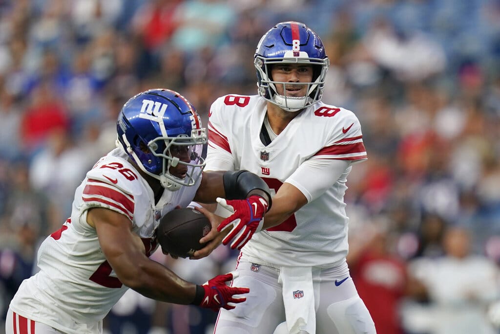 Media by Associated Press - New York Giants quarterback Daniel Jones (8) hands off to running back Saquon Barkley (26) during the first half of the team's preseason NFL football game against the New England Patriots, Thursday, Aug. 11, 2022, in Foxborough, Mass. (AP Photo/Charles Krupa)