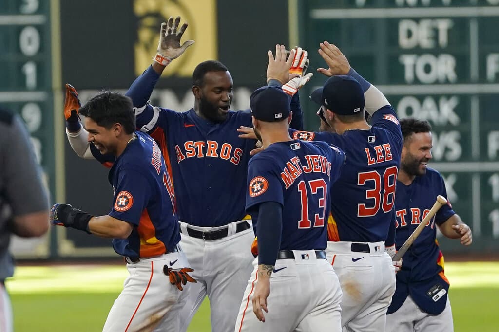 Media by Associated Press - Houston Astros' Yordan Alvarez, second from left, celebrates with teammates after hitting a game-winning RBI-single against the Seattle Mariners during the 10th inning of a baseball game Sunday, July 31, 2022, in Houston. The Astros won 3-2 in 10 innings. (AP Photo/David J. Phillip)