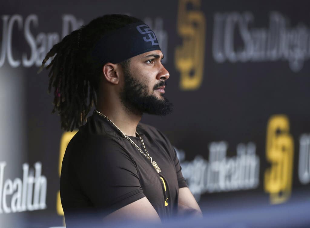 Media by Associated Press - FILE - San Diego Padres' Fernando Tatis Jr. looks out from the dugout prior to the team's baseball game against the Philadelphia Phillies on June 25, 2022, in San Diego. Tatis was suspended 80 games by Major League Baseball on Friday, Aug. 12, after testing positive for a performance-enhancing substance. The penalty was effective immediately, meaning the All-Star shortstop cannot play in the majors this year. Tatis had been on the injured list all season after breaking his left wrist in spring training. (AP Photo/Derrick Tuskan, File)