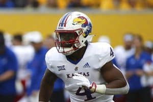 Media by Associated Press - Kansas running back Devin Neal (4) runs during the first half of an NCAA college football game against West Virginia in Morgantown, W.Va., Saturday, Sept. 10, 2022. (AP Photo/Kathleen Batten)