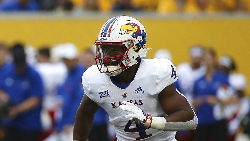 Media by Associated Press - Kansas running back Devin Neal (4) runs during the first half of an NCAA college football game against West Virginia in Morgantown, W.Va., Saturday, Sept. 10, 2022. (AP Photo/Kathleen Batten)