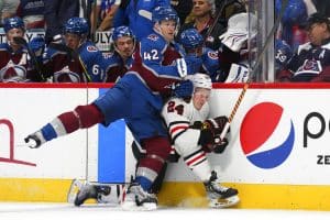 Media by Associated Press - Colorado Avalanche defenseman Josh Manson (42) checks Chicago Blackhawks center Sam Lafferty (24) into the boards during the third period of an NHL hockey game Wednesday, Oct. 12, 2022, in Denver. The Avalanche won 5-2. (AP Photo/Jack Dempsey)