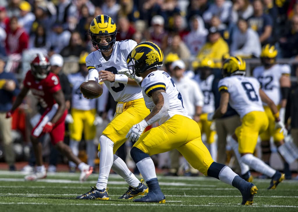 Media by Associated Press - Michigan quarterback J.J. McCarthy (9) hands off to running back Blake Corum (2) during an NCAA college football game, Saturday, Oct. 8, 2022, in Bloomington, Ind. (AP Photo/Doug McSchooler)