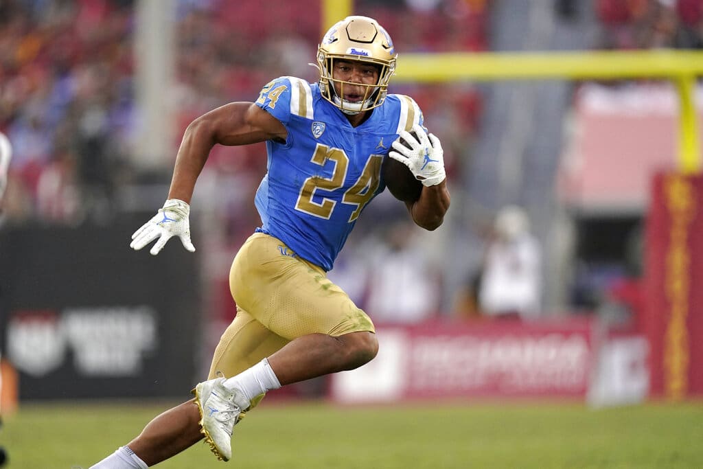 Media by Associated Press - UCLA running back Zach Charbonnet runs the ball during the second half of an NCAA college football game against Southern California Saturday, Nov. 20, 2021, in Los Angeles. UCLA won 62-33. If the Bruins are going to contend for the Pac-12 title, it will need big seasons again from quarterback Dorian Thompson-Robinson and running back Zach Charbonnet. UCLA opens the season on Sept. 4 against Bowling Green. (AP Photo/Mark J. Terrill, File)