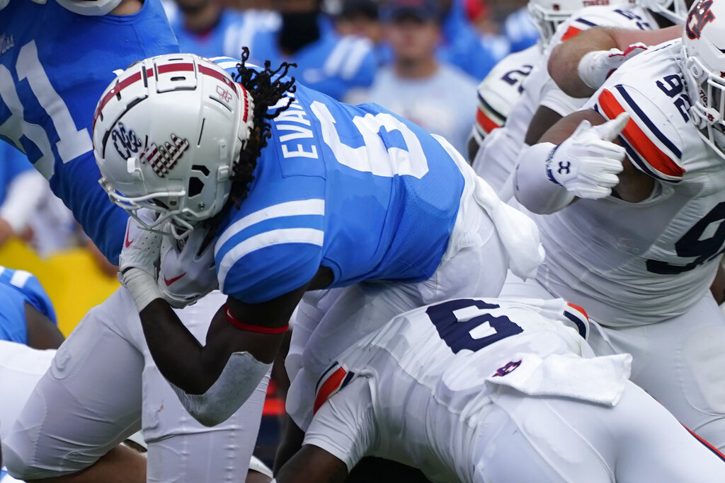 Media by Associated Press - Mississippi running back Zach Evans (6) carries the ball and dives over Auburn cornerback Keionte Scott (6) during the first half of an NCAA college football game against Mississippi in Oxford, Miss., Saturday, Oct. 15, 2022. Mississippi won 48-34. (AP Photo/Rogelio V. Solis)