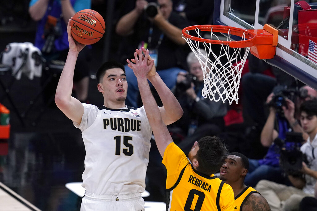 Media by Associated Press - FILE - Purdue center Zach Edey (15) shoots over Iowa forward Filip Rebraca (0) during the second half of an NCAA college basketball game at the Big Ten Conference tournament, Sunday, March 13, 2022, in Indianapolis. Edey is one of the most intimidating players in the conference. (AP Photo/Michael Conroy, File)