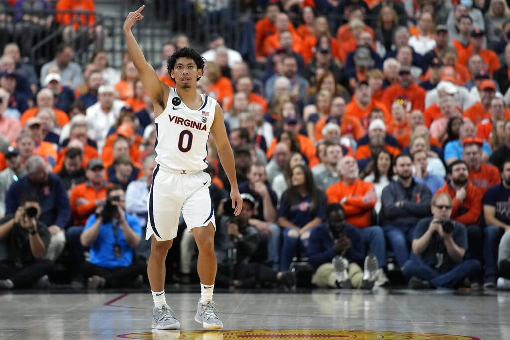 Media by Associated Press - Virginia's Kihei Clark (0) celebrates after making a 3-point shot against Illinois during the first half of an NCAA college basketball game Sunday, Nov. 20, 2022, in Las Vegas. (AP Photo/John Locher)