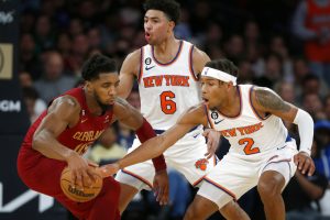 Media by Associated Press - Cleveland Cavaliers guard Donovan Mitchell, left, is defended by New York Knicks guards Quentin Grimes (6) and Miles McBride (2) during the second half of an NBA basketball game, Sunday, Dec. 4, 2022, in New York. The Knicks won 92-81. (AP Photo/John Munson)