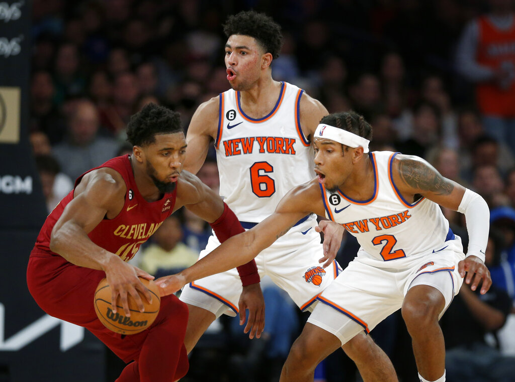 Media by Associated Press - Cleveland Cavaliers guard Donovan Mitchell, left, is defended by New York Knicks guards Quentin Grimes (6) and Miles McBride (2) during the second half of an NBA basketball game, Sunday, Dec. 4, 2022, in New York. The Knicks won 92-81. (AP Photo/John Munson)