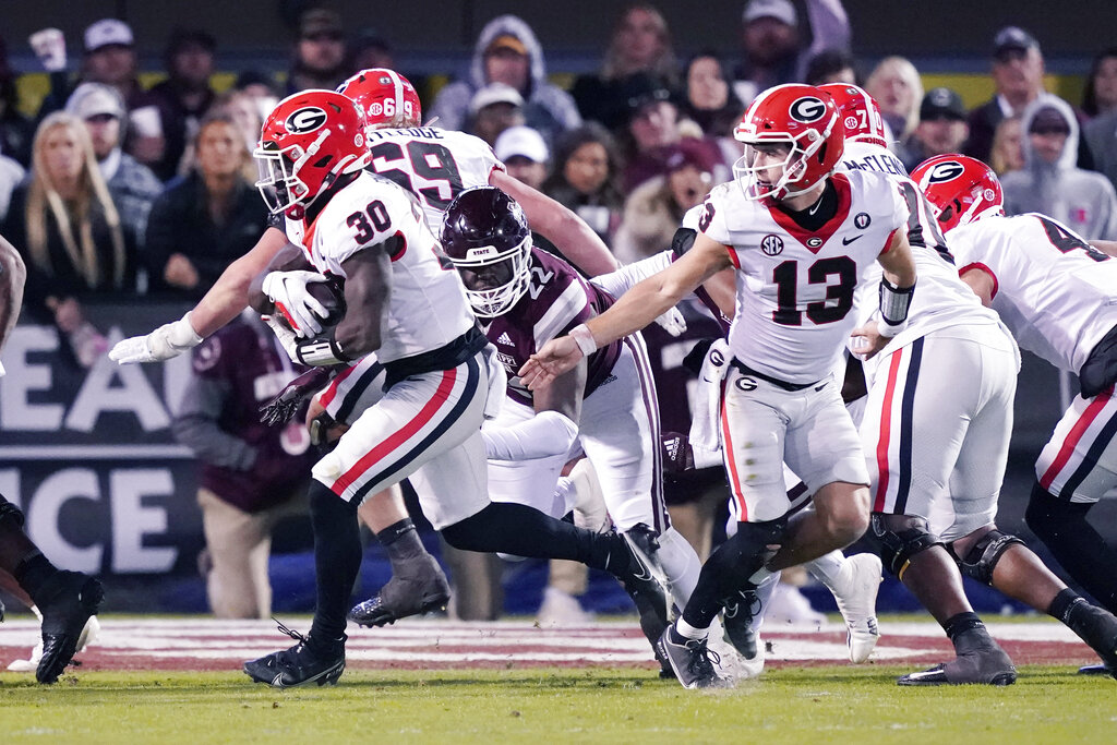 Media by Associated Press - Georgia running back Daijun Edwards (30) takes a hand off from quarterback Stetson Bennett (13) while Mississippi State defensive tackle Nathan Pickering (22) pursues in the second half of an NCAA college football game in Starkville, Miss., Saturday, Nov. 12, 2022. Georgia won 45-19. (AP Photo/Rogelio V. Solis)