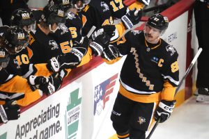 Pittsburgh Penguins' Sidney Crosby (87) returns to the bench after scoring during the first period of an NHL hockey game against the Carolina Hurricanes in Pittsburgh, Thursday, Dec. 22, 2022. (AP Photo/Gene J. Puskar) - Media by Associated Press