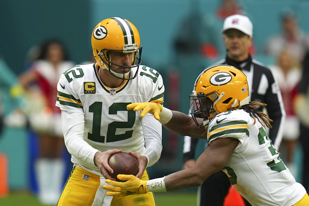 Media by Associated Press - Green Bay Packers quarterback Aaron Rodgers (12) hands off to Green Bay Packers running back Aaron Jones (33) during the second half of an NFL football game against the Miami Dolphins, Sunday, Dec. 25, 2022, in Miami Gardens, Fla. (AP Photo/Jim Rassol)