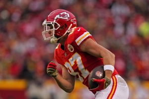 Media by Associated Press - Kansas City Chiefs tight end Travis Kelce runs the ball during the first half of an NFL football game against the Los Angeles Rams Sunday, Nov. 27, 2022, in Kansas City, Mo. (AP Photo/Charlie Riedel)