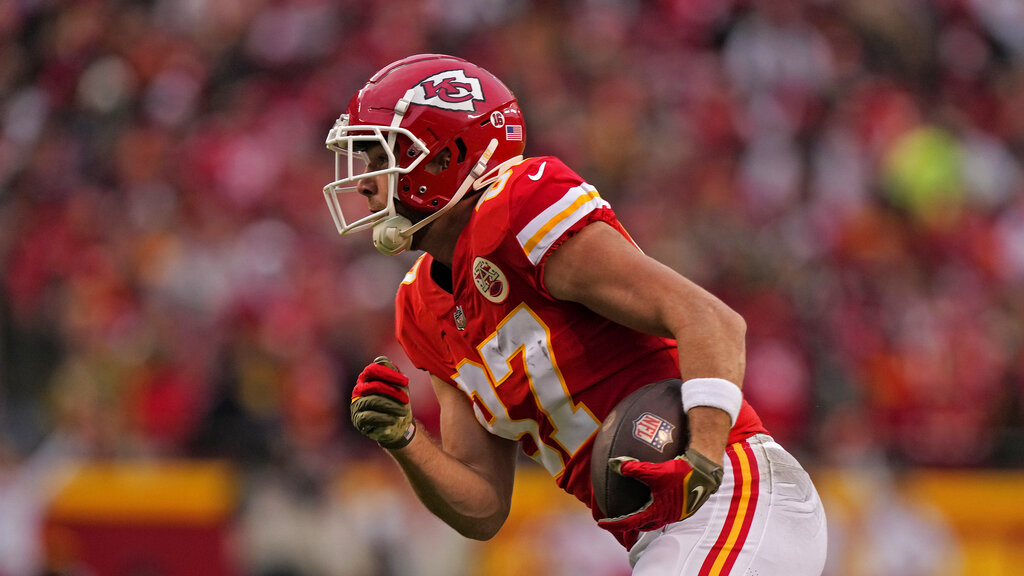 Media by Associated Press - Kansas City Chiefs tight end Travis Kelce runs the ball during the first half of an NFL football game against the Los Angeles Rams Sunday, Nov. 27, 2022, in Kansas City, Mo. (AP Photo/Charlie Riedel)