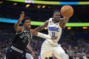 Media by Associated Press - Orlando Magic center Mo Bamba (11) gains control of a rebound in front of San Antonio Spurs guard Josh Richardson (7) during the second half of an NBA basketball game, Friday, Dec. 23, 2022, in Orlando, Fla. (AP Photo/Phelan M. Ebenhack)