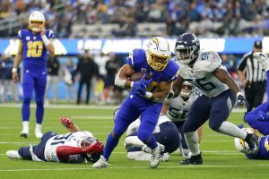 Media by Associated Press - Los Angeles Chargers running back Austin Ekeler, middle, runs against the Tennessee Titans during the second half of an NFL football game in Inglewood, Calif., Sunday, Dec. 18, 2022. (AP Photo/Marcio Jose Sanchez)