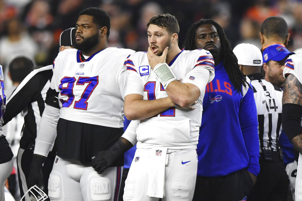 Media by Associated Press - Buffalo Bills quarterback Josh Allen (17) pauses as Damar Hamlin is examined by medical staff during the first half of an NFL football game against the Cincinnati Bengals, Monday, Jan. 2, 2023, in Cincinnati. (AP Photo/Emilee Chinn)