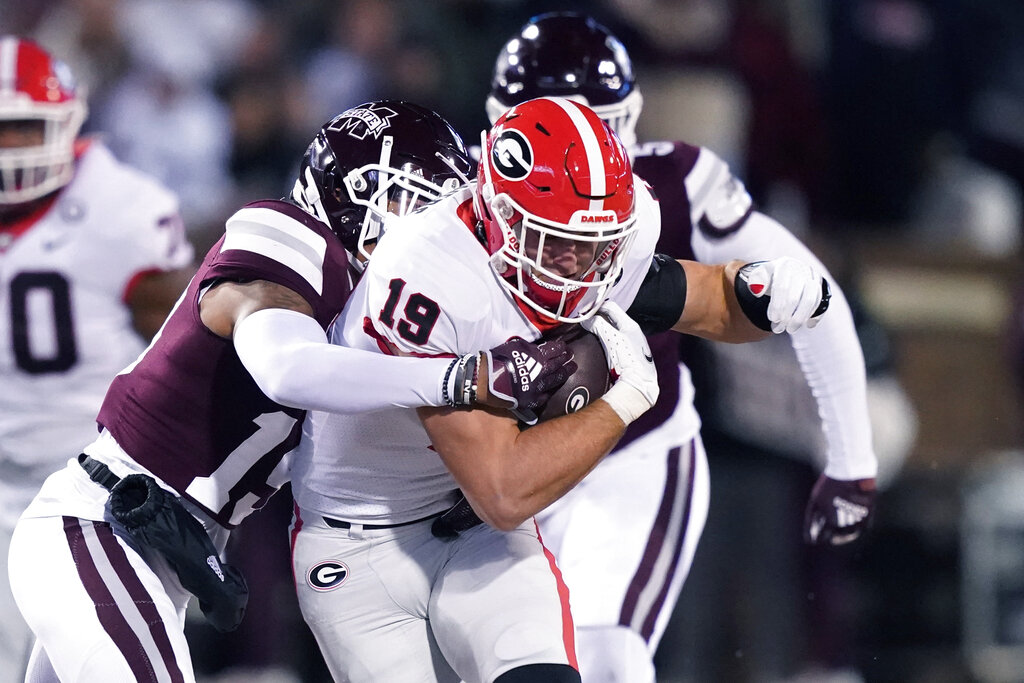 Media by Associated Press - Georgia tight end Brock Bowers (19) runs through some Mississippi State defenders following a pass reception during the first half of an NCAA college football game in Starkville, Miss., Saturday, Nov. 12 2022. Georgia won 45-19. (AP Photo/Rogelio V. Solis)