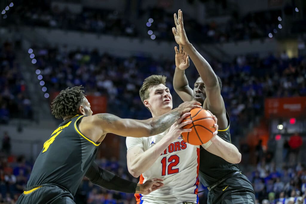 Media by Associated Press - Florida forward Colin Castleton (12) gets fouled by Missouri Tigers guard DeAndre Gholston (4) under pressure from Missouri Tigers forward Mohamed Diarra, right, during the second half of an NCAA college basketball game Saturday, Jan. 14, 2023, in Gainesville, Fla. Florida won 73-64.(AP Photo/Alan Youngblood)