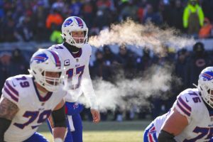 Buffalo Bills quarterback Josh Allen (17) and tackle Spencer Brown (79) exhale before a successful two-point attempt in the second half of an NFL football game against the Chicago Bears in Chicago, Saturday, Dec. 24, 2022. (AP Photo/Charles Rex Arbogast) - Media by Associated Press