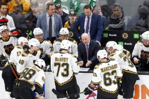 Boston Bruins head coach Jim Montgomery talks to him team during a timeout in the third period of an NHL hockey game against the Buffalo Sabres, Saturday, Dec. 31, 2022, in Boston. (AP Photo/Mary Schwalm) - Media by Associated Press