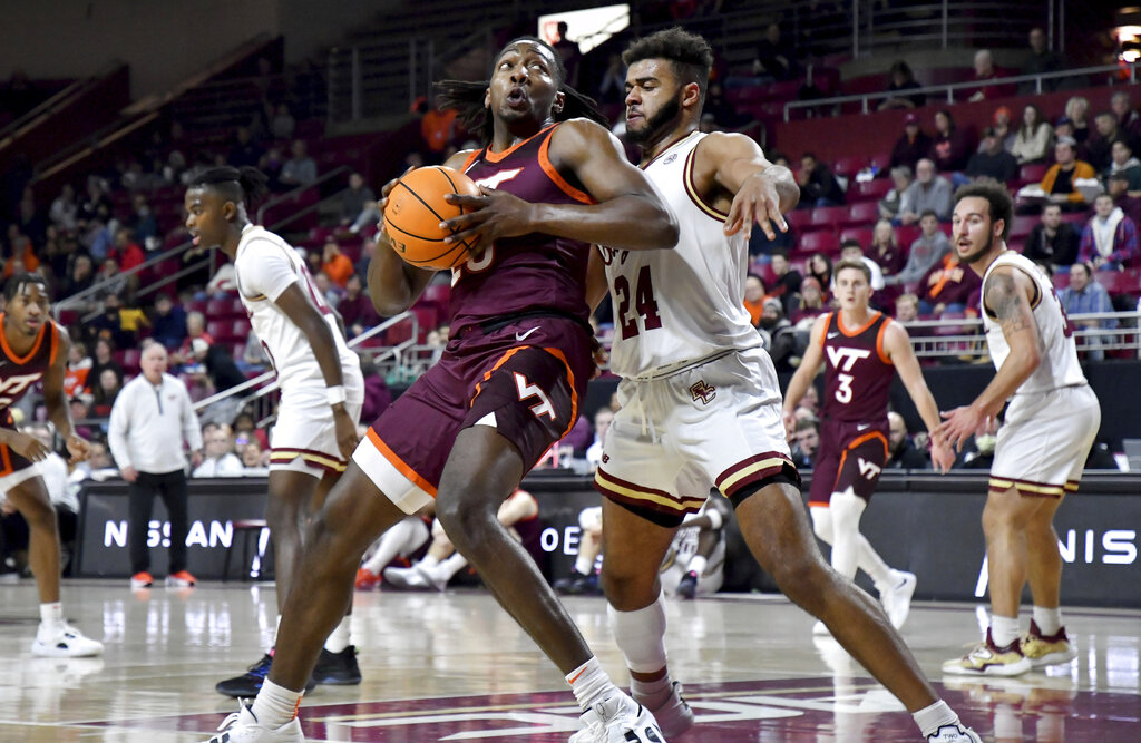 Media by Associated Press - Virginia Tech's Justyn Mutts attempts to score under defensive pressure from Boston College's Jonathan Noel (24) during the first half of an NCAA college basketball game, Wednesday, Dec. 21, 2022, in Boston. (AP Photo/Mark Stockwell)