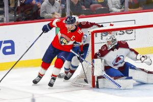 Media by Associated Press - Florida Panthers center Aleksander Barkov (16) drives the puck past Colorado Avalanche defenseman Bowen Byram (4) and goaltender Alexandar Georgiev (40) during the third period of an NHL hockey game Saturday, Feb. 11, 2023, in Sunrise, Fla. (AP Photo/Reinhold Matay)