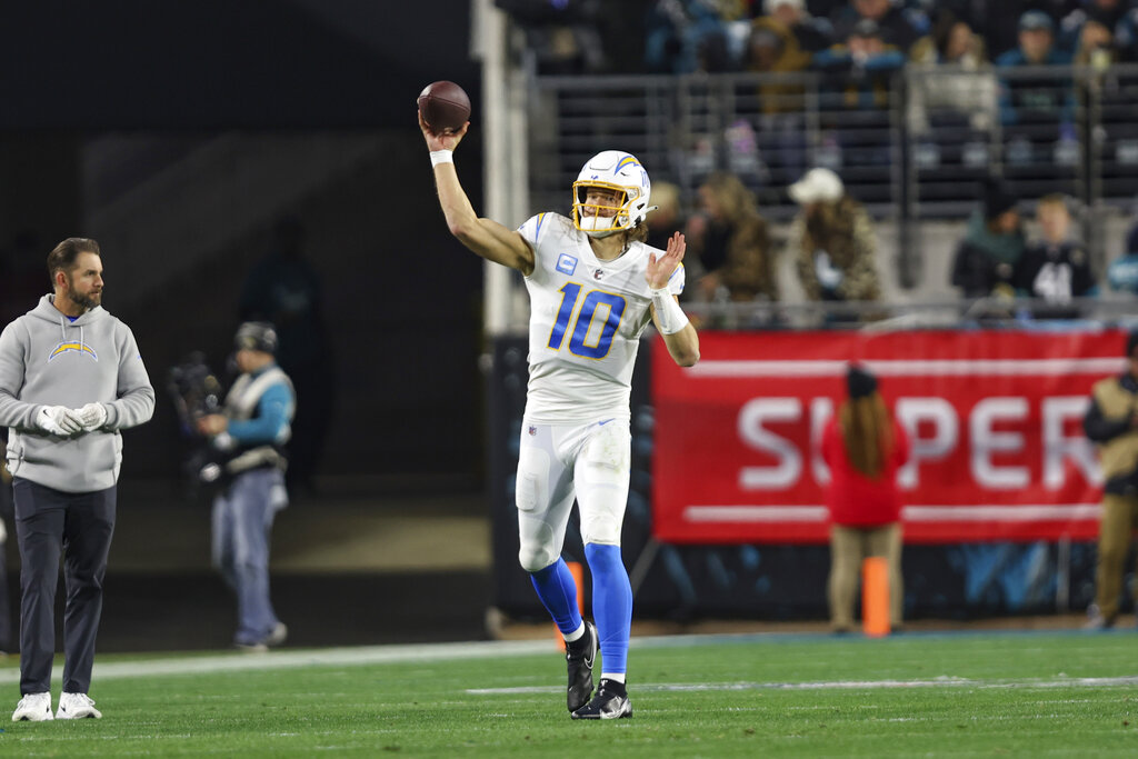 Media by Associated Press - Los Angeles Chargers quarterback Justin Herbert (10) warms up near the sideline during an NFL wild-card football game against the Jacksonville Jaguars, Saturday, Jan. 14, 2023, in Jacksonville, Fla. The Jaguars defeated the Chargers 31-30. (AP Photo/Gary McCullough)