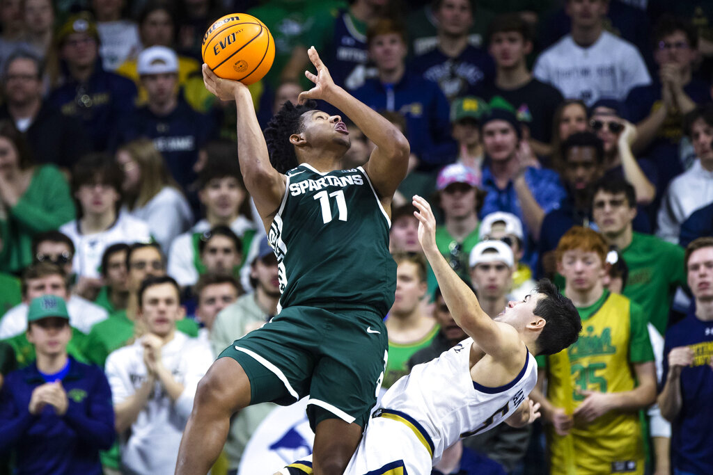 Media by Associated Press - Michigan State's A.J. Hoggard (11) collides with Notre Dame's Cormac Ryan (5) during the second half of an NCAA college basketball game Wednesday, Nov. 30, 2022, in South Bend, Ind. (AP Photo/Michael Caterina)