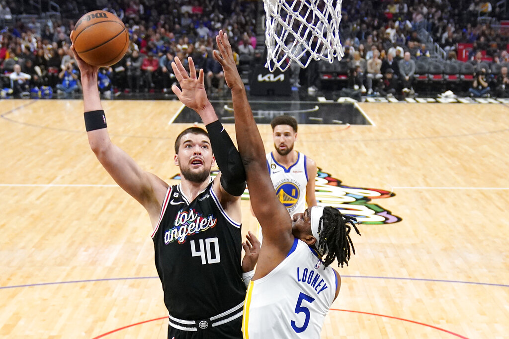 Media by Associated Press - Los Angeles Clippers center Ivica Zubac, left, shoots as Golden State Warriors forward Kevon Looney defends during the first half of an NBA basketball game Tuesday, Feb. 14, 2023, in Los Angeles. (AP Photo/Mark J. Terrill)