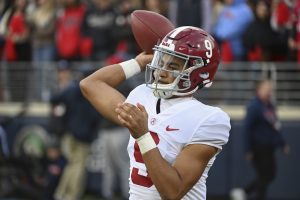 Media by Associated Press - FILE - Alabama quarterback Bryce Young (9) warms up on the sidelines during the first half of an NCAA college football game against Mississippi in Oxford, Miss., Saturday, Nov. 12, 2022. The Panthers have traded up to acquire the No. 1 overall pick in the draft from the Chicago Bears in exchange for Carolina's No. 9 and No. 61 overall picks in 2023, a first-round pick in 2024, a second-round pick in 2025 and star wide receiver D.J. Moore, two people familiar with the deal said Friday, March 10, 2023, The people spoke to The Associated Press on condition of anonymity because the trade had not been announced. The move allows the Panthers to acquire a potential franchise quarterback, although it remains unclear which player the team prefers. (AP Photo/Thomas Graning, File)