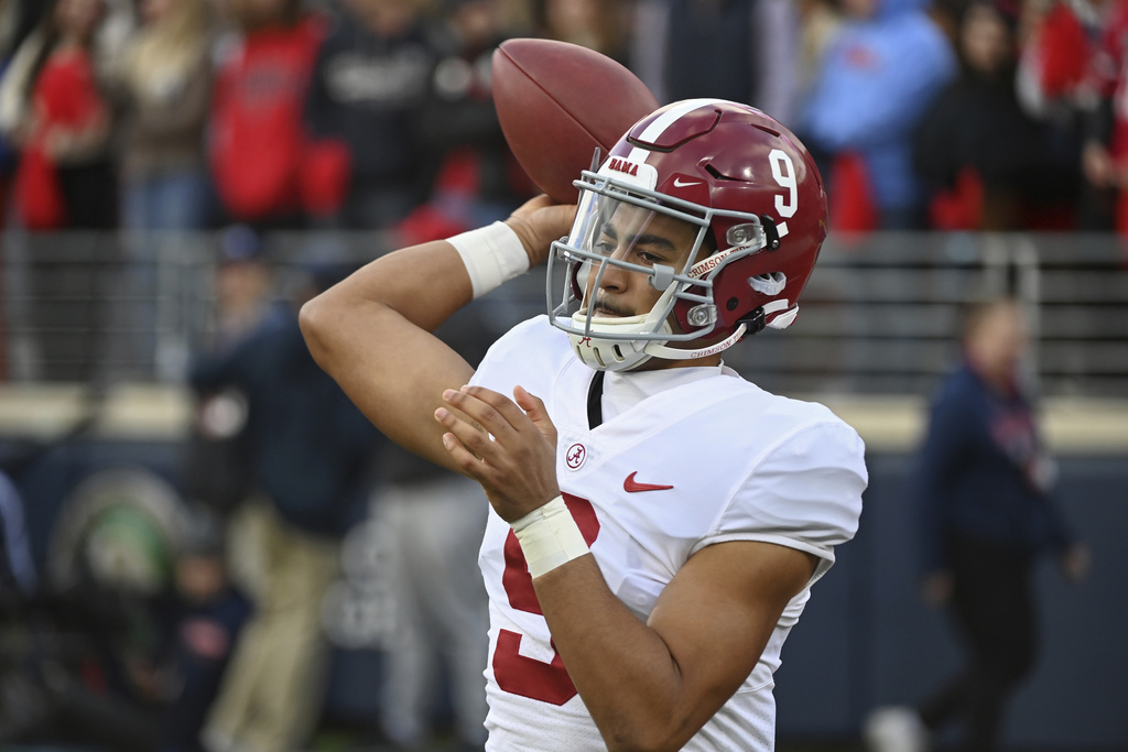 Media by Associated Press - FILE - Alabama quarterback Bryce Young (9) warms up on the sidelines during the first half of an NCAA college football game against Mississippi in Oxford, Miss., Saturday, Nov. 12, 2022. The Panthers have traded up to acquire the No. 1 overall pick in the draft from the Chicago Bears in exchange for Carolina's No. 9 and No. 61 overall picks in 2023, a first-round pick in 2024, a second-round pick in 2025 and star wide receiver D.J. Moore, two people familiar with the deal said Friday, March 10, 2023, The people spoke to The Associated Press on condition of anonymity because the trade had not been announced. The move allows the Panthers to acquire a potential franchise quarterback, although it remains unclear which player the team prefers. (AP Photo/Thomas Graning, File)