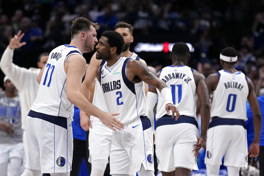 Media by Associated Press - Dallas Mavericks' Luka Doncic (77) and Kyrie Irving (2) celebrate after Irving sunk a three-point shot in the second half of an NBA basketball game against the Utah Jazz, Tuesday, March 7, 2023, in Dallas. (AP Photo/Tony Gutierrez)