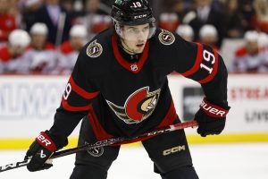 Media by Associated Press - Ottawa Senators right wing Drake Batherson (19) watches face off against the New Jersey Devils during the first period of an NHL hockey game, Saturday, March 25, 2023, in Newark, N.J. (AP Photo/Noah K. Murray)