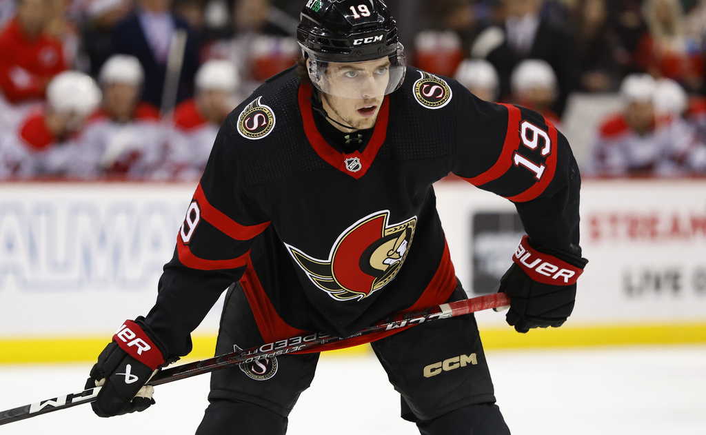 Media by Associated Press - Ottawa Senators right wing Drake Batherson (19) watches face off against the New Jersey Devils during the first period of an NHL hockey game, Saturday, March 25, 2023, in Newark, N.J. (AP Photo/Noah K. Murray)