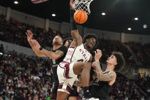 Media by Associated Press - Mississippi State guard Cameron Matthews (4) watches as he scores a layup basket between Texas A&M guard Dexter Dennis (0) and forward Andersson Garcia (11) during the second half of an NCAA college basketball game in Starkville, Miss., Saturday, Feb. 25, 2023. Mississippi State won 69-62. (AP Photo/Rogelio V. Solis)