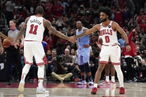 Media by Associated Press - Chicago Bulls guard Coby White, right, celebrates with forward DeMar DeRozan after scoring a basket during the second half of an NBA basketball game against the Memphis Grizzlies in Chicago, Sunday, April 2, 2023. (AP Photo/Nam Y. Huh)